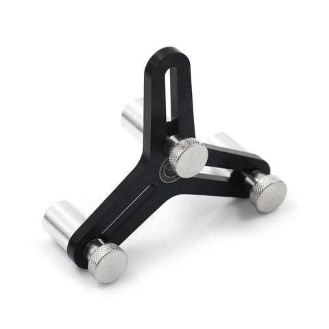 Universal piston ring squaring tool, angled view; black metal with silver knurled adjustment knobs for 2-5 inch bores