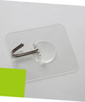 Super Tough Clear Adhesive Wall Hooks 12 Pack Stainless Steel Zero Mess Peel Strong Grip No Drill Install Holds Up Perfect For Kitchen Bedroom Hanging Setup You Gotta Get Your Hands On This, showing clear hook on adhesive pad.