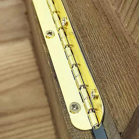 Close-up of a golden metal hinge installed on a wooden surface for Two Pack Golden Metal Hinges For Cabinets And Furniture Hardware Long Gold Hinges For Jewelry Boxes And Wooden Cases Antique Vintage Look Slick For Farmhouse Decor And DIY Furniture Repair Projects.