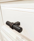 Oil Rubbed Bronze Cabinet Bar Pulls 10 Pack Two And Three Eighths Inch Long One Half Inch Bar Diameter One And Five Sixteenths Inch Projection Includes Mounting Screws Solid Steel Cosmas 181ORB installed on white cabinet