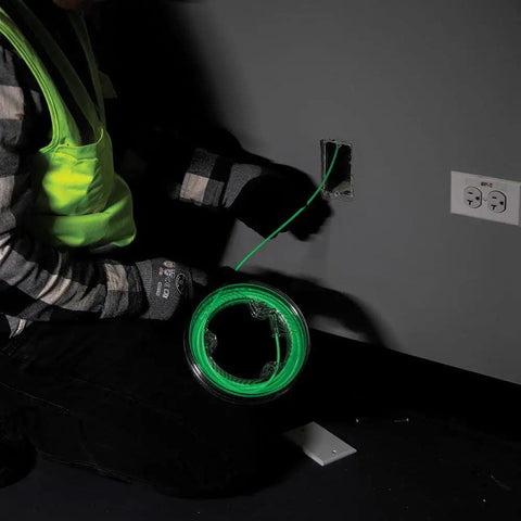 Electrician using Glow In The Dark 20 Foot Fiberglass Fish Tape With Nylon Tip And Stainless Steel Connector Removable Case for wiring.