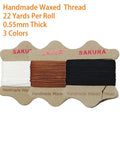 Three spools of 0.55mm waxed thread in black, white, and brown colors, part of the Upholstery Repair Kit With 0.55mm Waxed Thread And Heavy Duty Needles For Leather Canvas And Quilting Includes Three Colors Black White Brown And Seven Tools For DIY Quick Easy Repairs At Home Or On The Go.