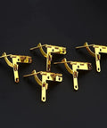 Antique 31x30mm 90 Degree Spring Hinge Set for small boxes and cabinets, 5 pack, iron with retro gold finish, arranged on black background.