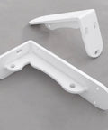 Super Tough White Iron Wall Mount Floating Shelf Brackets With Reinforced Triangle Brace To Haul Heavy Loads Without Breaking A Sweat Includes Complete Mounting Kit For Easy Setup That Actually Holds Up, featuring two welded white iron brackets.