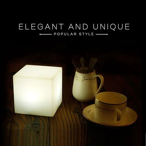 4 Inch Dimmable LED Night Light Mood Cube With 16 RGB Colors, 8 Level Dimming on wooden table, next to cups and utensils