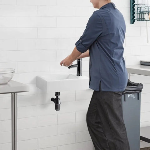 Person using Space Saving Compact Ceramic Corner Wall Mounted Sink For Small Bathrooms White Finish With Right Side Faucet Hole Sink Only
