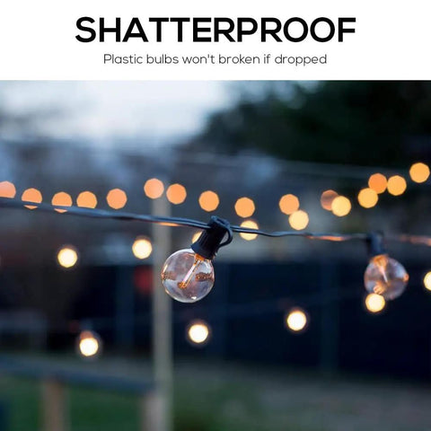Shatterproof 48Ft Outdoor String Lights With Warm White And RGB 2 In 1 Bulbs hanging in a garden setting at dusk