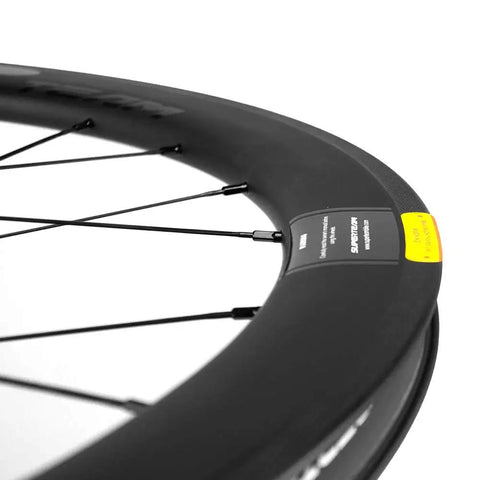 Close-up of Beefy 50mm Deep Carbon Wheelset tubeless rim and basalt braking surface with visible spokes.