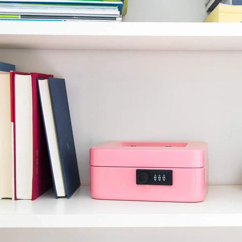 Medium Cash Box With Combination Lock, Built Tough Metal Money Safe With Removable Tray, Pink Finish, on shelf between books