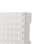 Slick Wall Mounted Pegboard Organizer With Hassle Free Punch Free Design And Legit Abs Durability, showcasing a white perforated surface.