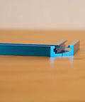 Close-up of Dope 3 Inch T Track Intersection Kit with predrilled mounting holes made from anodized aluminum on wooden surface.