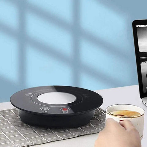 Fast Acting USB Mug Warmer With Smart Adjustable Heat Control Keeps Your Morning Sip Piping Hot All Day Long Sleek Black Tempered Glass Platform on a desk with a cup of tea.
