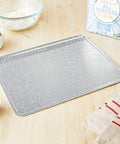 Pro Grade Aluminum Bake Pan 10 By 14 Inch Pebble Pattern Cookie Sheet Oven Safe To 428 F on kitchen counter with ingredients