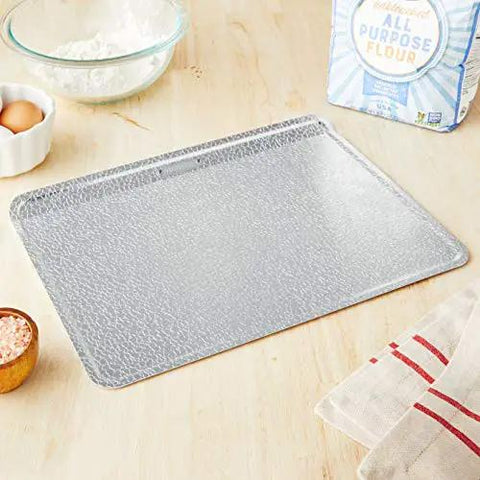 Pro Grade Aluminum Bake Pan 10 By 14 Inch Pebble Pattern Cookie Sheet Oven Safe To 428 F on kitchen counter with ingredients