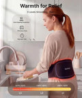 Person washing dishes wearing Dope Cordless Heating Pad for Back Pain with 3 in 1 Red Light Therapy Belt in kitchen setting