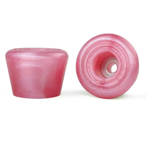 Pink rubber roller skate toe stops, viewed from side and bottom with mounting hole for screws.