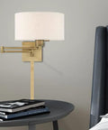 Bronze Finish One Light Swing Arm Wall Lamp With Oatmeal Fabric Shade shown on bedroom nightstand, no bulbs included.