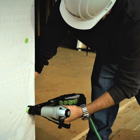 Person using Cap Stapler For Roofing Felt Foam Insulation And House Wrap On The Job Ready Lightweight Pneumatic Nailer 18 Gauge