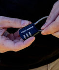 Small Stainless Steel Combination Cable Lock For Overland Truck Racks Custom Combo Code in a user's hand.