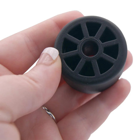 Hand holding black Refrigerator Rear Caster Wheel Replacement For DA61-04703A 2033808, 1.5-inch diameter by 1-inch wide