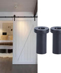 Built Tough Bottom Spacers For Sliding Barn Doors, Matte Black Wall Spacers With Door Shaft Pins, shown installed on a white barn door