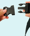 Hands holding One Point Five Inch Quick Side Release Buckles Eight Pack Go To Heavy Duty Plastic Buckles For Backpacks Luggage Dog Harness Nylon Webbing And Straps Easy Snap Fasteners In Black, showing clasp detail.