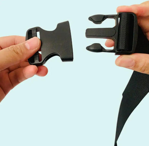 Hands holding One Point Five Inch Quick Side Release Buckles Eight Pack Go To Heavy Duty Plastic Buckles For Backpacks Luggage Dog Harness Nylon Webbing And Straps Easy Snap Fasteners In Black, showing clasp detail.