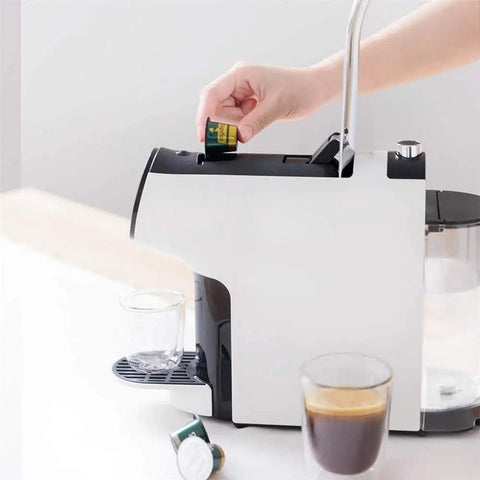 Side view of Durable Smart Capsule Coffee Machine With Drip Free Design No Mess One Tap Operation Two Modes Italian Espresso And American Coffee Compact Electric Brewer For Home Use with capsule being inserted.