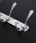 Two Piece Five Hook Wall Mounted Coat Rack Made From Solid Stainless Steel Featuring A Polished Mirror Finish Great For Bathrooms Bedrooms And Hallways A Real Deal Storage Solution close-up of hooks on polished surface