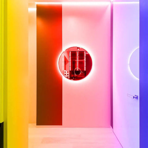 Colorful room with Battery Operated RGB LED Strip Lights 13.12 Ft Color Changing Strip illuminating round mirror.