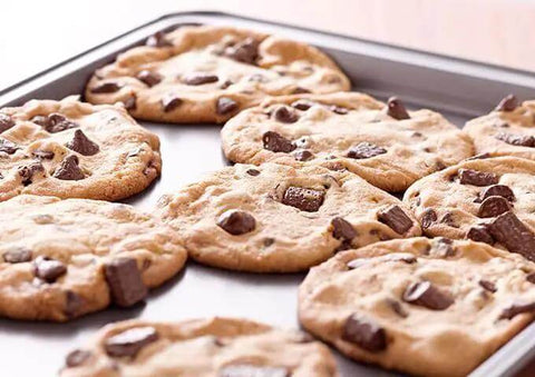Commercial Grade Aluminum Sheet Pan Full Size With Reinforced Rim holding baked chocolate chip cookies.