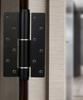 Black invisible door hinge with automatic closer and hydraulic spring damping self closing positioning for cabinets and furniture.