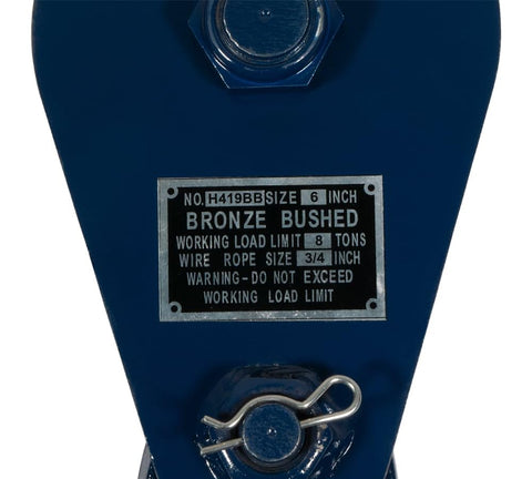 Close-up of label on 8 Ton Snatch Block with 6 inch sheave, wire rope size 3/4 inch, industrial grade blue heavy duty load block.