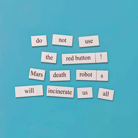 Nerdy Engineer Word Magnet Kit on blue surface with magnetic tiles forming a humorous warning message about robots.
