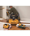 Top Shelf 6 Gallon Electric Air Compressor With Oil Free Pancake Tank And 150 Psi Pressure in use with finishing tools.