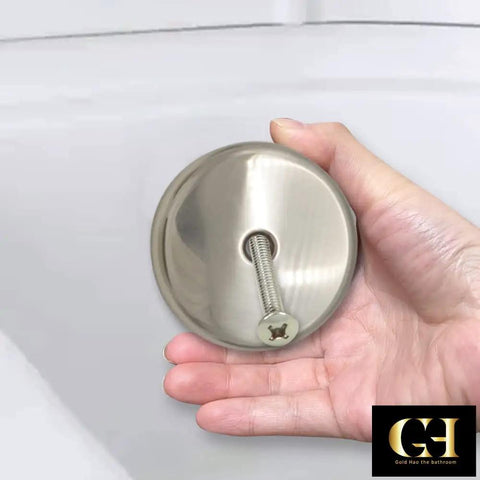 Top Shelf Single Hole Bathtub Overflow Drain Cover Plate With Brushed Nickel Finish held in hand, showcasing its metal build and screw detail.