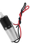 Garosa 6mm geared motor with metal body, black top, white drive shaft, red/black wiring.