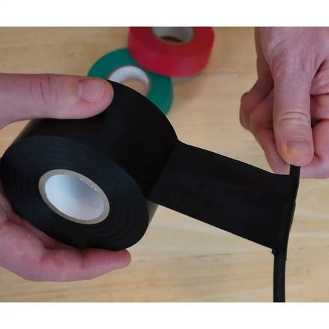 Person using Bulk 48 Roll Carton Electrical Tape Black Waterproof Heavy Duty Pro Grade Vinyl Self Adhesive PVC Wire Insulation