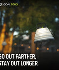 Crush Light Solar Powered Camping Lantern hanging outdoors during evening, with collapsible design and USB rechargeable battery.