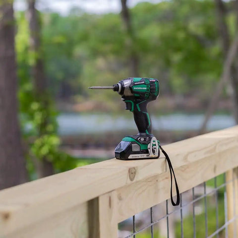 18V MultiVolt Cordless Triple Hammer Impact Driver Kit on fence, One Quarter Inch Hex Chuck, 1,832 in-lbs torque tool outdoors