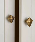 Antique Bronze Cabinet Knobs And Drawer Pulls Two Pack With Boho Geometric Silhouettes on white cupboard doors.