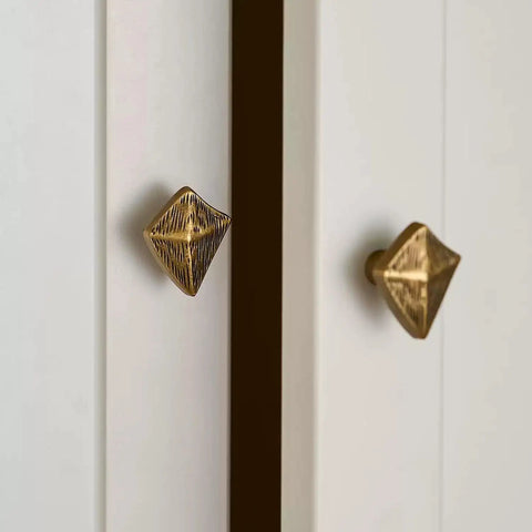 Antique Bronze Cabinet Knobs And Drawer Pulls Two Pack With Boho Geometric Silhouettes on white cupboard doors.