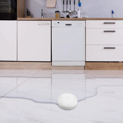 Smart Water Leak Detector 2 Pack With WiFi Alerts And 75 DB Alarm For Instant App Notifications Battery Included Easy Wire Free Design in kitchen on tile floor.