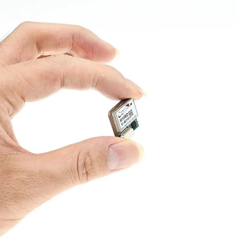 Hand holding Lit Tiny M10SD 10Hz FPV GPS Compass Module for RC Drones, ultra lightweight 18mm square 4.8g UBX M10 GNSS chip.