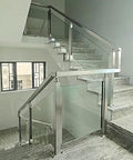 Stainless Steel 304 Railing Post Kit For Outdoor Decks And Stairs Featuring Adjustable Mounts And A Brushed Silver Finish Fit For 10 To 12 Mm Glass Panels Bringing Rock Solid Protection And Top Tier Modern Vibes installed on a stairway with glass panels.
