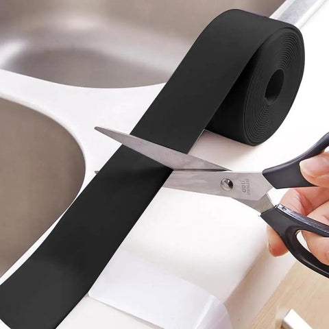Gotcha Check Out This Durable Shower Sink Bath Wall Caulk Sealing Strip Tape With An Anti Stain Self Adhesive Design being cut with scissors.