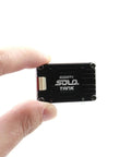 Person holding 5.8G VTX Video Transmitter 1.6W High Power With Built In Microphone compact black CNC shell.