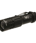 Compact black flashlight from Outdoorsman Survival Combo Knife kit, with adjustable beam and clip, shown at an angle