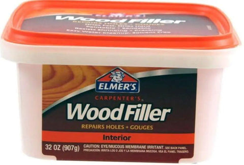 Close-up of 32 oz Elmer's wood filler container for repairs, labeled "Interior Wood Filler For Quick Fixes Fast Dry Paintable And Sandable Formula"