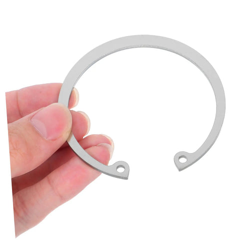 Close-up of a hand holding a piece from the 5 Piece Stainless Steel C Clip Retaining Ring Kit for Grooved Shafts Easy Install Snap Ring Set